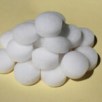 White,Camphor,Tablet,On,A,Yellow,Background